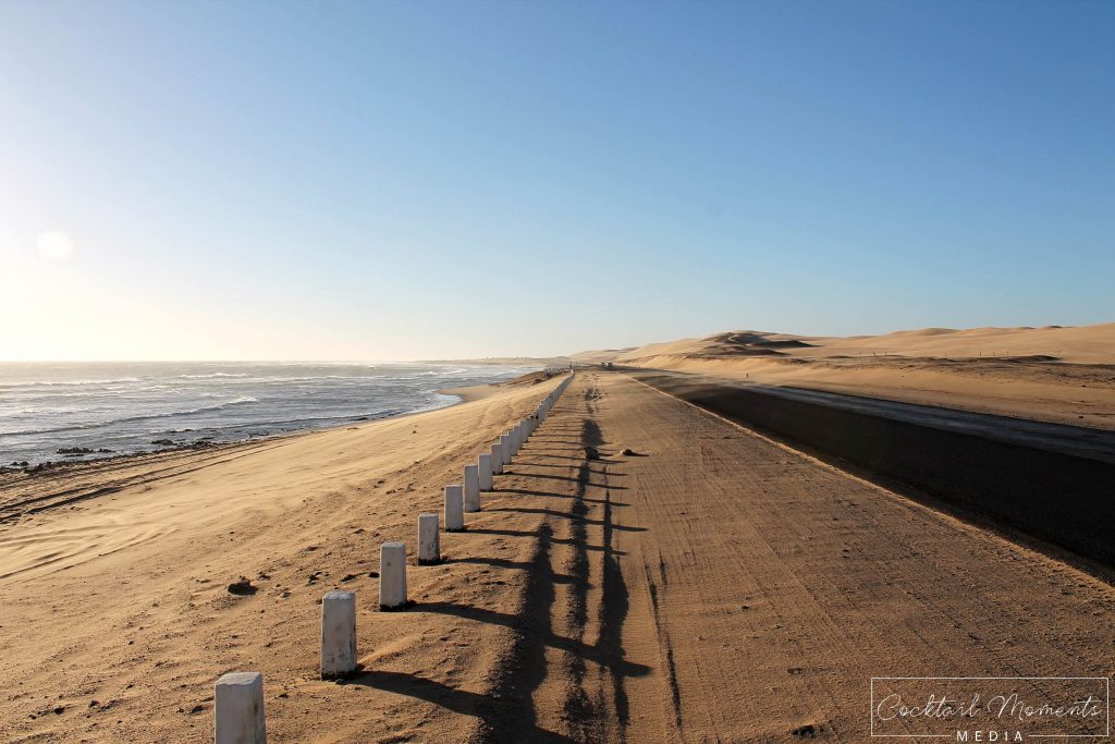 Atlantic Ocean and Namib Desert separated by a road (Swakopmund)